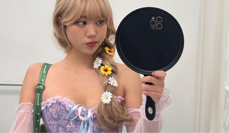 a woman cosplaying as Rapunzel with a fun custom phone case of a frying pan